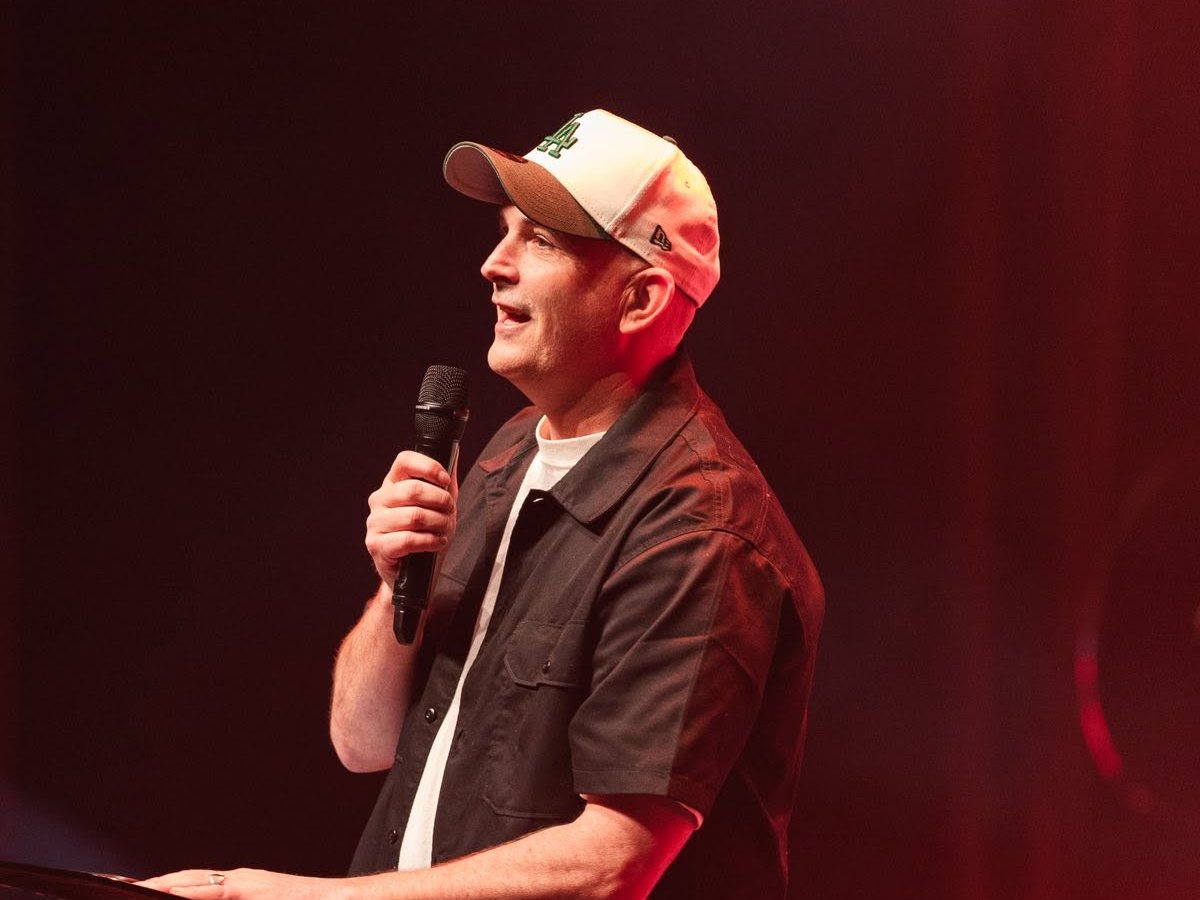 Sam Monk speaking on stage